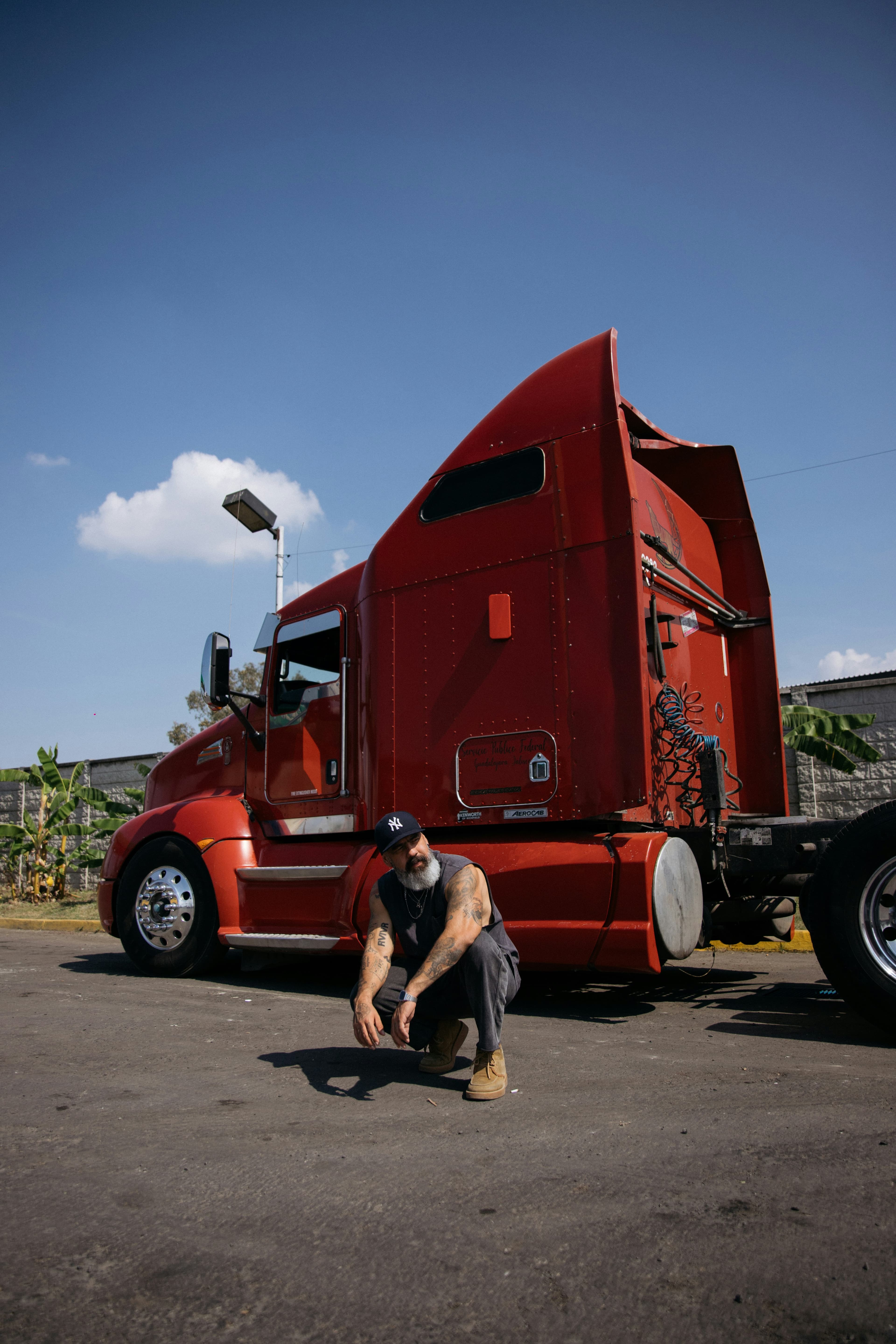 Professional truck driver in front of a tractor